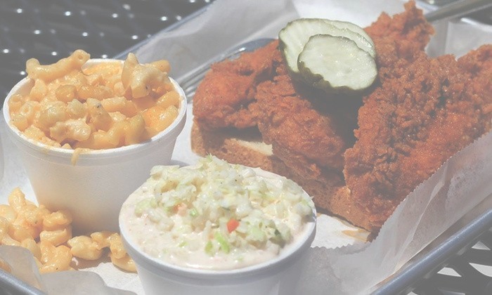 Fried chicken with macaroni and cheese, coleslaw, and pickles